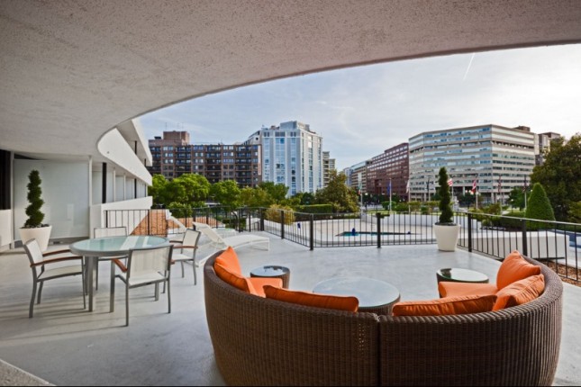 A balcony with outdoor furniture and a city view
